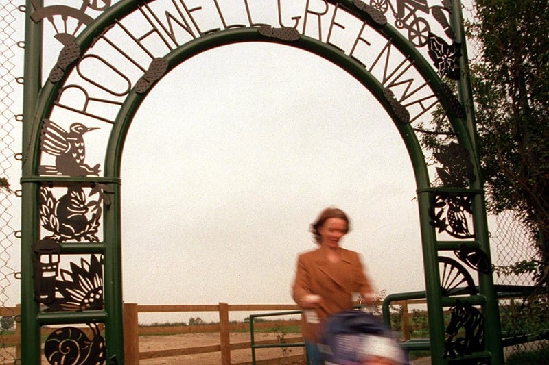 Artist Lyndele Fozaed along with her young daughter Francesca is pictured walking underneath the arch she designed to mark the start of the South Leeds Heritage Trail at Rothwell. Pictured in October 1997.