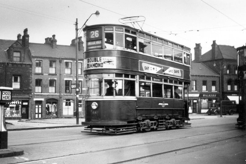 Woodhouse Lane showing Chamberlain tram no. 441, destination Belle Isle in September 1951. The properties in the background, including Walker's Ltd., butchers, at no. 79 towards the right, are on Raglan Road, which branches off from Woodhouse Lane at this point.