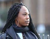 Image of a black woman looking thoughtfully into the distance