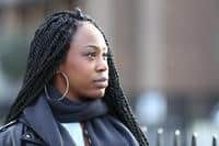 Image of a black woman looking thoughtfully into the distance