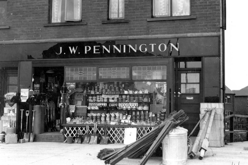 The ironmongery business of J.W. Pennington on the Ring Road pictured in June 1937. Tools, wood and goods can be seen displayed in shop window and on the pavement outside.