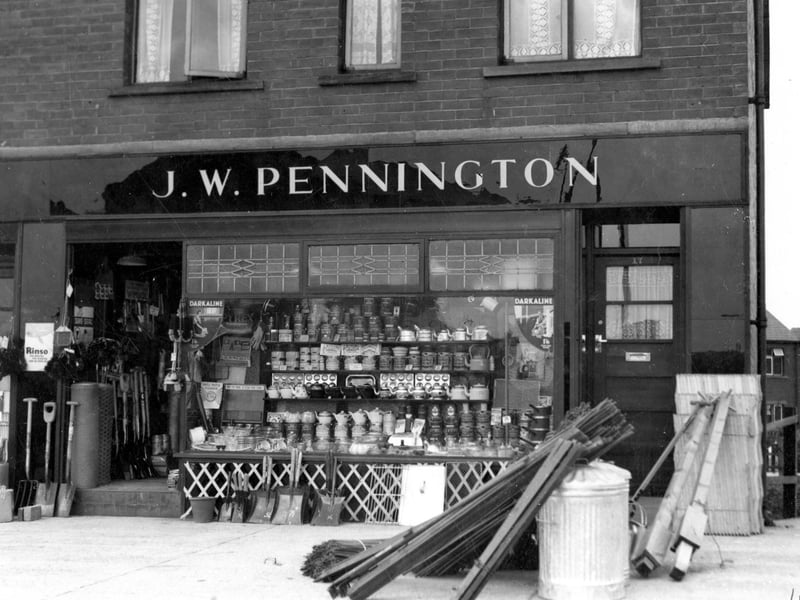 The ironmongery business of J.W. Pennington on the Ring Road pictured in June 1937. Tools, wood and goods can be seen displayed in shop window and on the pavement outside.