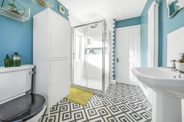 The stylish and extended house bathroom has a four piece suite in white.