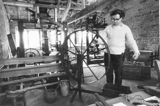 Marchj 1972 and Colne Valley Museum at Golcar was preparing to open for Easter. Pictured is  museum director Hugh Bodey threading a wool iron winding frame.