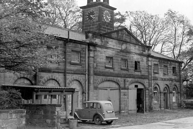 Stone built stables with slate roofs at The Mansion in October 1944. A clock tower is in the centre above double stable doors.