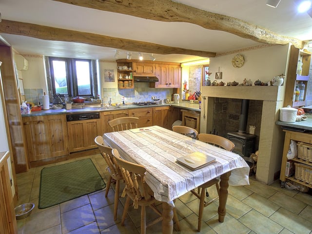 The beamed 'hub' of the home, with woodburning stove.