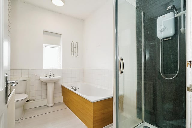 The modern bathroom is nicely decorated and has both a bath and seperate shower.
