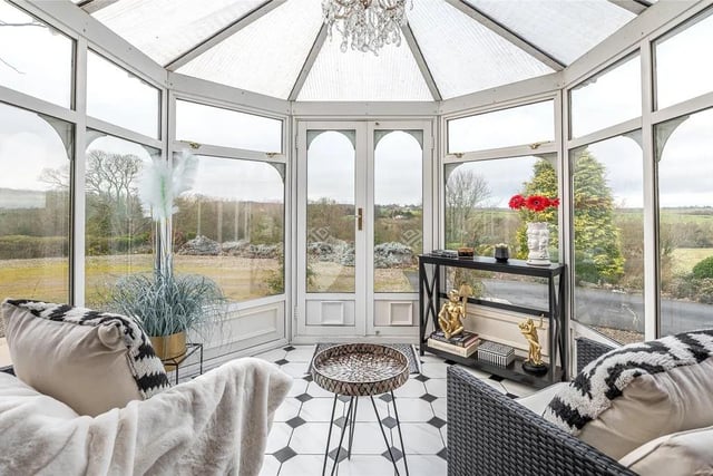 A conservatory extension acts as the property's formal entrance, leading to a grand landing hall.