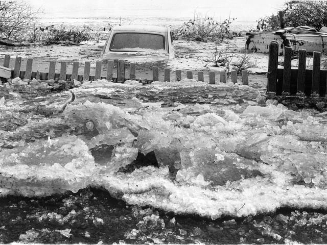 Packed ice surrounds a frozen car on Bondgate in January 1982.