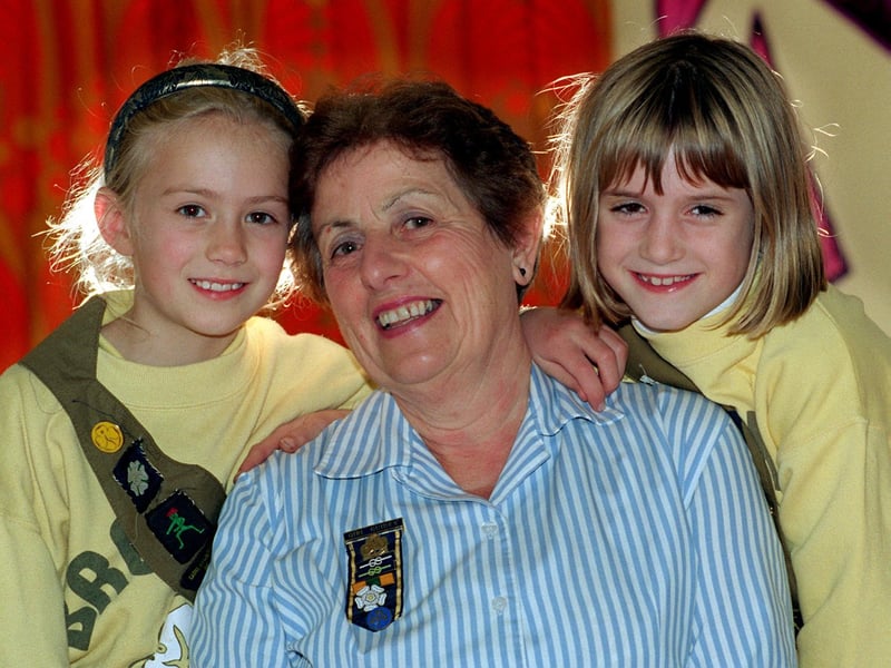 Maisy Coggan, Brown Owl for the 1st Thorner Brownies, was retiring after 25 years in October 1996. She is pictured receiving a farewell hug, from left, Natalie Bell and Ruth Voisey.