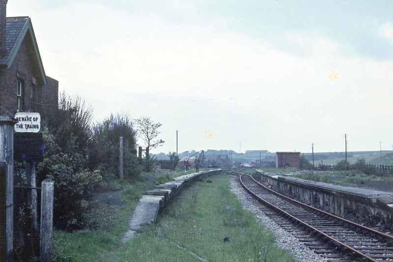 Derelict Woodkirk Station looking in the direction of Batley in May 1968. A sign on the left says 'Beware of the Trains'.