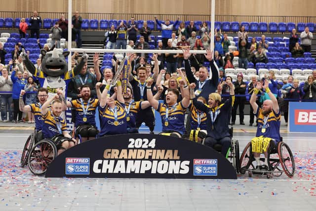 Leeds Rhinos players celebrate with the trophy following last year's Betfred Wheelchair Super League Grand Final win against Halifax Panthers. Picture by John Clifton/SWpix.com.