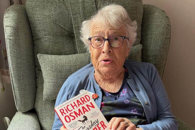 Resident at HC-One’s Hambleton Grange Care Home with The Thursday Murder Club novel