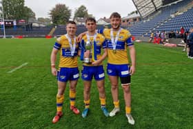Leeds Rhinos' Elliott Fox, Harry Smith and Noah Whittingham celebrate with the reserves Grand Final trophy following last week's win. All three are in the squad for Saturday's academy decider, also against Warrington Wolves.