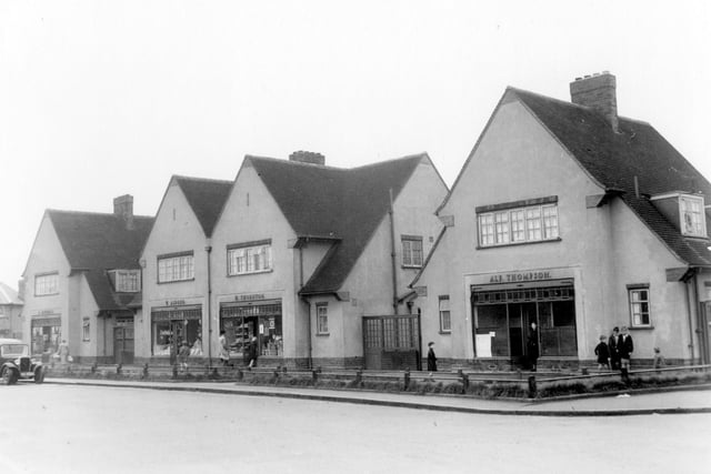 A parade of shops with living accommodation on Sissons Avenue in August 1939. . On the left is number 28, C. Mitchell, butcher. Moving right, number 26 Willie Aldred green grocer. Next to number 24 Harry Thornton grocer. Number 22 Alfred Thompson Fish & Chips. Shoppers and children can be seen.