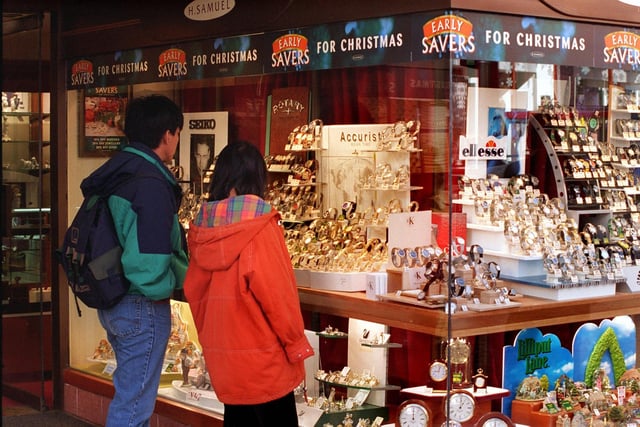 Shoppers look at the window display at H Samuel in November 1998.