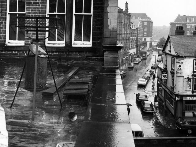 A view from roof at the back of George Street side of Kirkgate Market in January 1979, looking down to the north on George Street and Harewood Street. In the foreground are upper storeys of the market building and down below on George Street the Market Tavern can be seen.