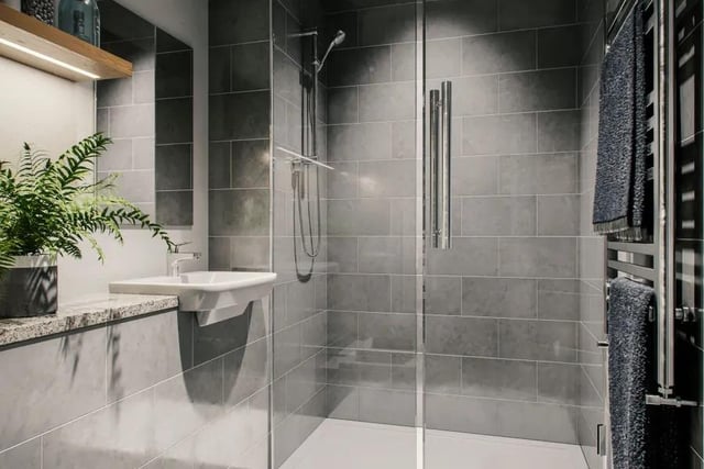 Slick, grey tiled bathrooms generate a clean and luxurious feel.