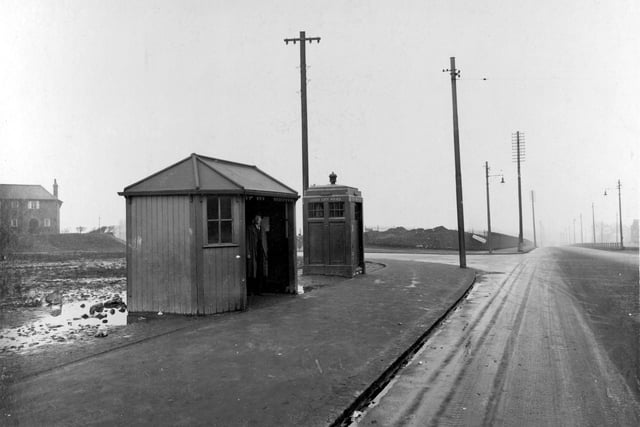 A bus shelter and Police box can be seen in this view looking from Stanningley Road towards the junction with Cockshott Lane in March 1936.