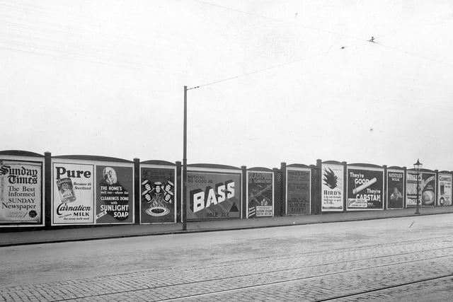 Advertising hoardings on Dewsbury Road in September 1932. They are, from left, The Sunday Times, Carnation Milk, Sunlight Soap, Heinz Soups, Bass Beer, Blackpool Illuminations, Beeston Picture House, Birds Custard, Capstan Cigarettes, Nestles Milk, Palethorpes Sausages and Guinness.