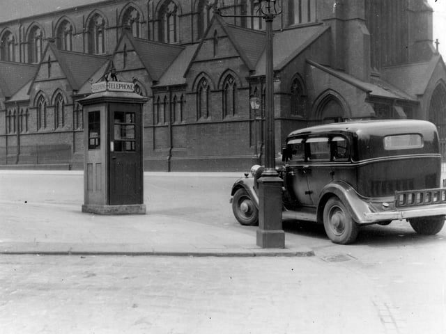 St. Patricks Church at the junction of York Road and Marsh Lane pictured in June 1936. On the corner there is a telephone kiosk and a gas streetlamp. A large black car is visible on the corner.