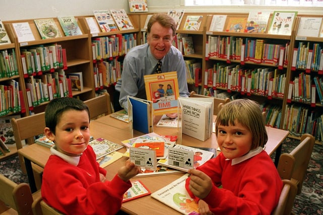 Joe Cooper and Caitlin Beever hold their smart cards in the new library at Ash Tree Primary School in September 1999 which was opened by MP Colin Burgon.