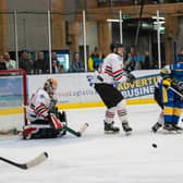 BIG TEST: Leeds Knights Carter Hamill and Zach Brooks battle for possession in front of the Basingstoke Bison net at Elland Road Ice Arena on Sunday night. Picture courtesy of Anna Alarie.