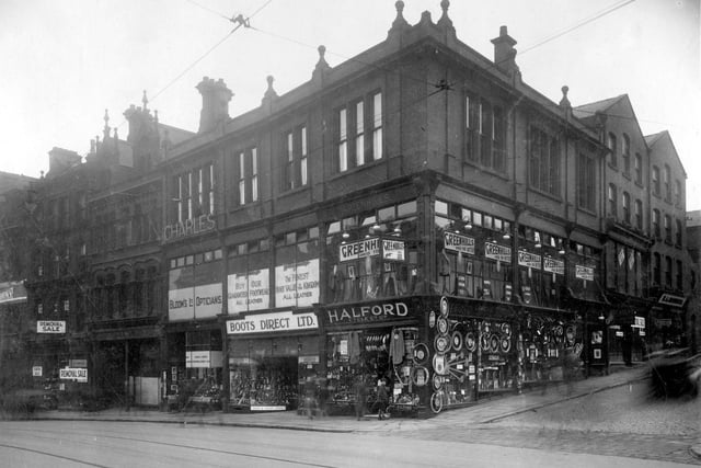 Businesses on corner of Mark Lane with New Briggate in August 1929. Right to left are Greenhills Tailors, Halford Cycle Co Ltd, Boots Direct Ltd, boot and shoe retailer and  Blooms Opticians.