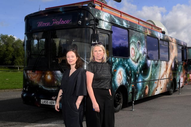 Kerry Harker (left) from the East Leeds Project and Abby Dix-Mason (right) from Foxglove are pictured with the Moon Palace touring bus at Fearnville Playing Fields, Leeds.