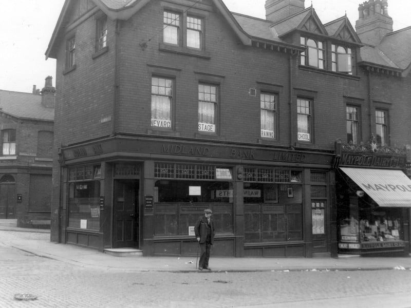 Midland Bank on corner of Malvern Road and Beeston Road in June 1938. To left of the picture can be seen Brookdale Place with a pub on corner. Next to Midland Bank is Maypole Dairy Co. Ltd., with striped awning outside. A man is about to cross the road.