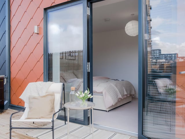 The master bedroom opens out onto the private decked area.