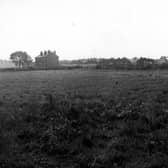 A view looking south west along the extension to Hunslet cemetery in September 1953. Houses on Middleton Road are visible in the background. A wooden fence can be seen at the back of the field.