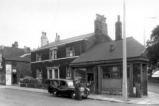 Armley Town Street in July 1960. On the left edge of this view a pet food and garden stores can be seen. Moving right are two through houses followed by a butchers business of E. Kaye and then the business premises of J. Haigh.