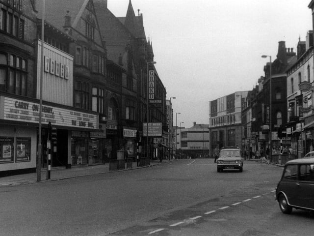 New Briggate looking south-west from the junction with Merrion Street, right, towards The Headrow. On the left, the Tower Cinema is showing the film 'Carry On Henry' with Sidney James and Kenneth Williams, which opened in the UK in 1971.
