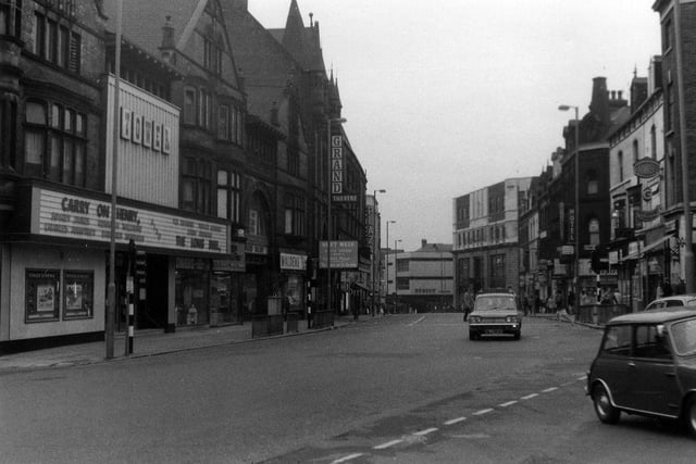 New Briggate looking south-west from the junction with Merrion Street, right, towards The Headrow. On the left, the Tower Cinema is showing the film 'Carry On Henry' with Sidney James and Kenneth Williams, which opened in the UK in 1971.