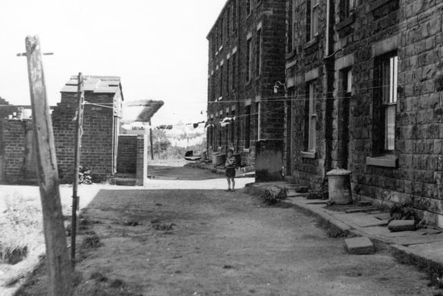 Clarence Street located just off Albert Road in June 1970. A small boy stands on the unmade access road. Washing hangs across the street.