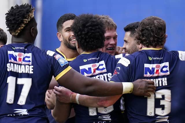 Tom Holroyd, third from right facing camera, celebrates after scoring in Rhinos' win over Catalans. Picture by Danny Lawson/PA Wire.