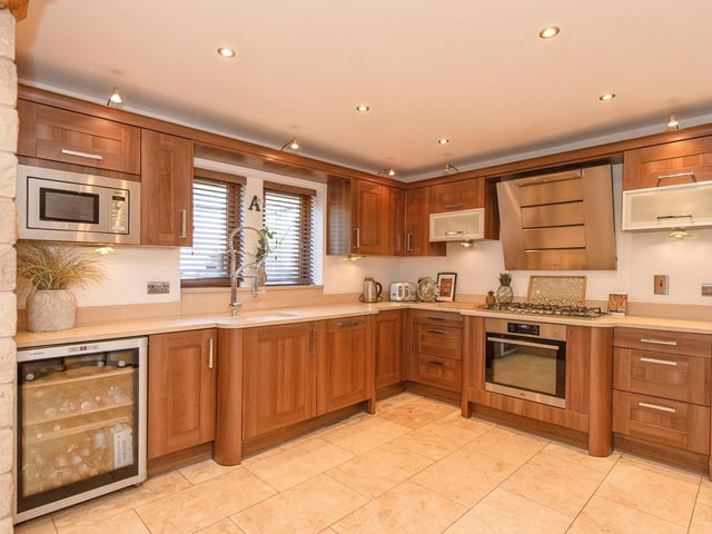 Wall and base units with granite work surfaces and integrated appliances feature within the high spec kitchen.
