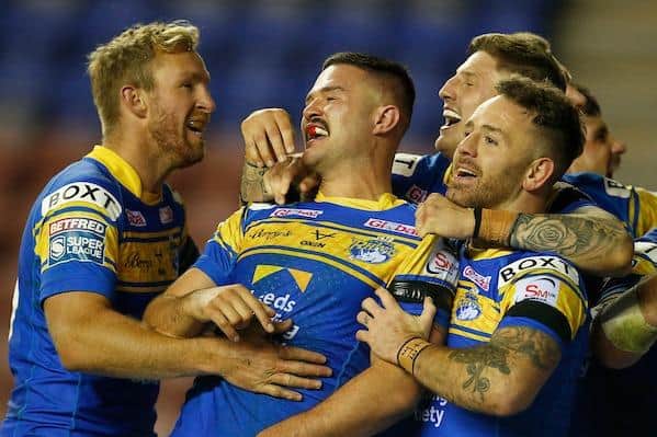 Matt Prior, left, joins in the celebrations after the second of James Bentley's three tries in Rhinos' semi-final win at Wigan. Picture by Ed Sykes/SWpix.com.