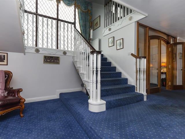 A spacious entrance hall with staircase leading up.