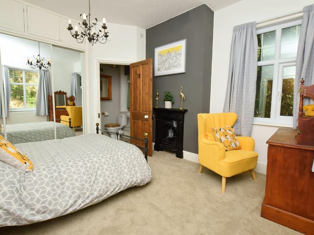 Spacious bedrooms have original fireplaces to add to their charm.