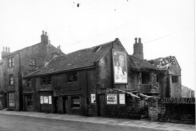 Old Hall, a derelict building on Bramley Town Street. A large poster advertises Player's Cigarettes; smaller ones publicise a local rugby match and a race meeting among others. Pictured in August 1956.