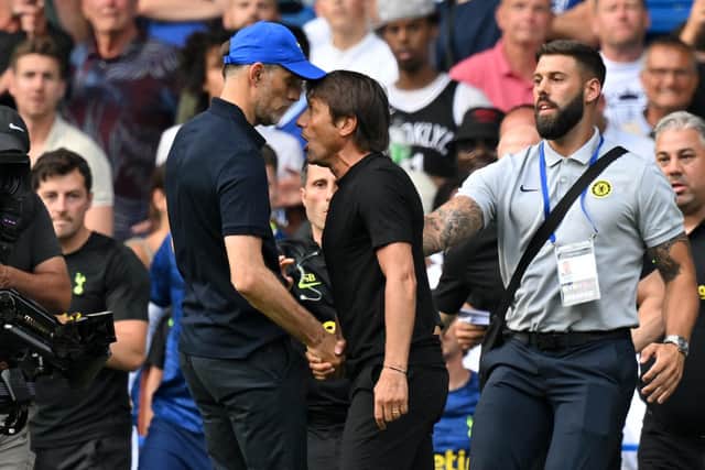 Thomas Tuchel (L) and Antonio Conte (R) clash before seeing red after the full time whistle at Stamford Bridge (Photo by GLYN KIRK/AFP via Getty Images)