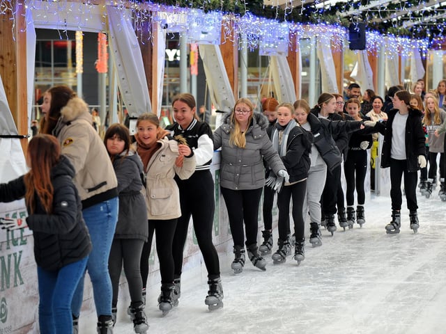 A group of skaters make their way onto the ice.