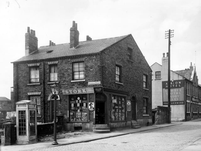 A grocers on Sackville Street in July 1958. Listed on the window for sale are potatoes, tomatoes, lettuce, cucumber and coal bricks. At this time open coal fires were still common. 'Coal bricks' were made of compacted coal dust, sawdust and cement powder, they were cheaper than coal and took much longer to burn. To the right on Buslingthorpe Lane is the Albion Hotel public house.