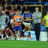 Ryan Hall gathers a kick from Danny McGuire and evades Scott Grix, now Leeds Rhinos' assistant-coach, to score the last-gasp try against Huddersfield Giants which secured the league leaders' shield in 2015. Picture by Steve Riding.