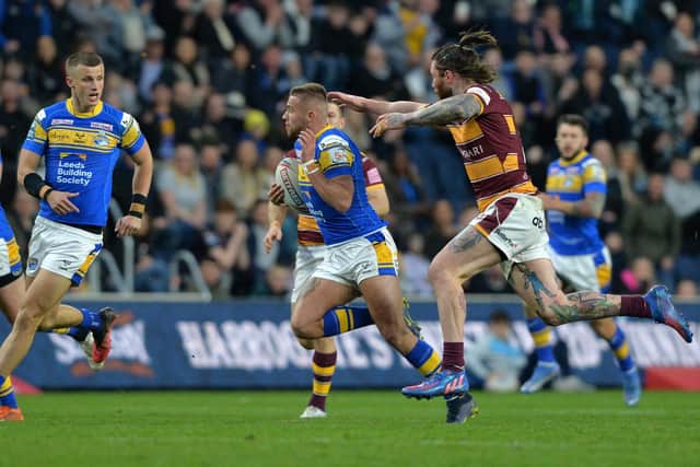 Jack Walker races away from Huddersfield's Chris McQueen shortly before suffering a long-term hamstring injury. Picture Bruce Rollinson.
