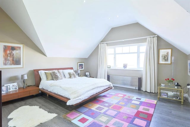 The master bedroom is particularly impressive, with a pitched ceiling with a network of spotlights inset.