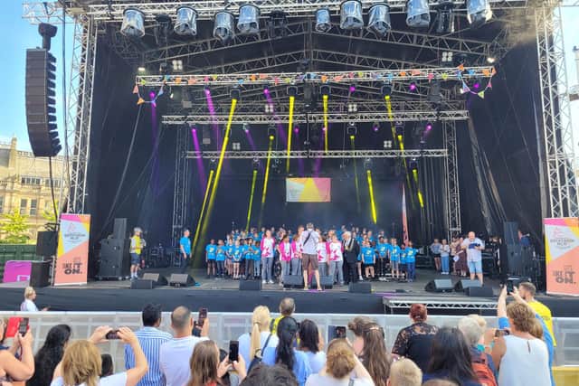 The Brownlees, centre, with kids' choir Class Dynamix onstage in Millennium Square.