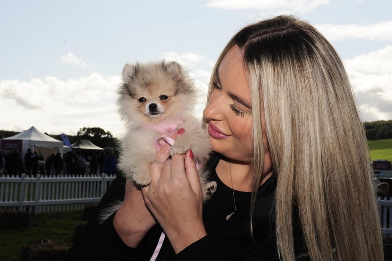 Revellers including Emily Parker brought their dogs down for the event, like this adorable miniature Pomeranian named Minnie.